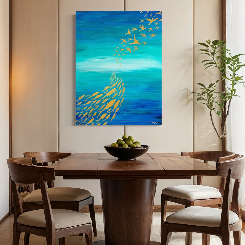 An artwork highlighting the importance of adaptability. “Be a fish in the sea and a bird in the sky”. The contrast of blue and gold will add a touch of sophistication to any space (home or office). Choose from framed or non-framed options for a touch of elegance. Displayed on a beige wall with wooden dining table.