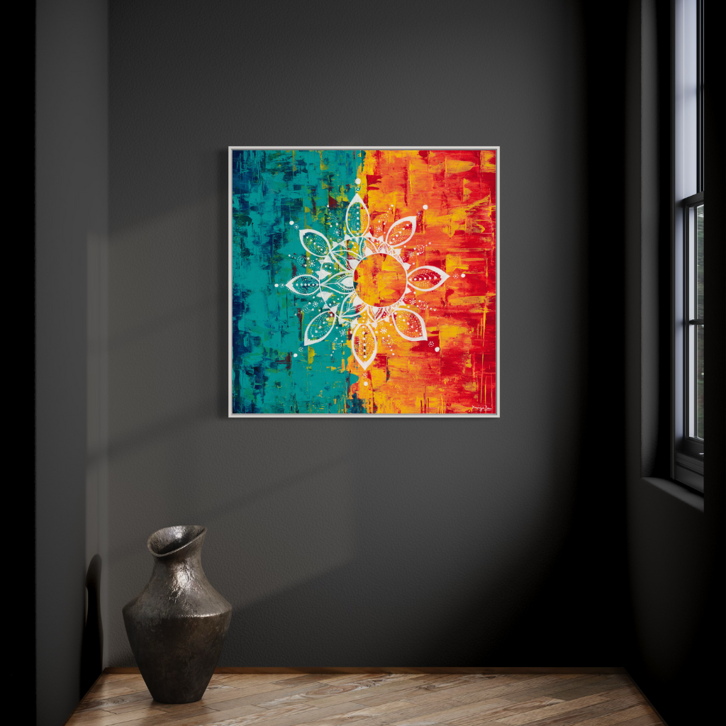 An exquisite Mandala artwork canvas print in white frame with the vibrant contrast of cool and warm colours. Handcrafted with precision to add a touch of elegance and calm to any space. Choose from framed or non-framed options. Displayed on a charcoal grey wall with rustic vase.