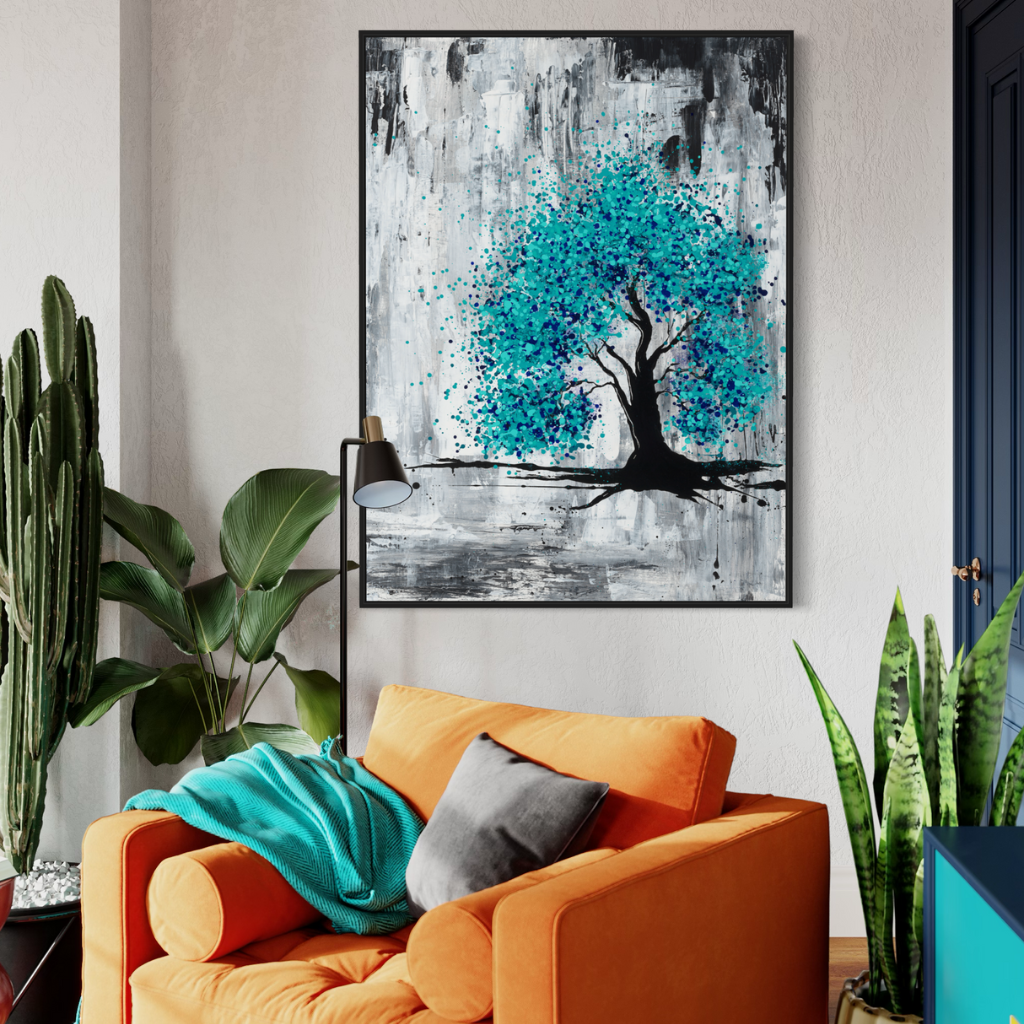 A black framed canvas print with burst of blue on a grey and charcoal background, perfectly captures hope in darkness. A perfect addition to fill positivity in any space. Displayed on a beige wall with orange chair and lots of plants in a cosy corner of the house..