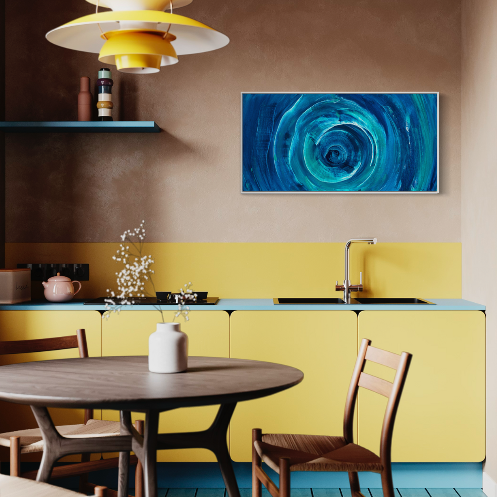 Add a splash of blue to your space with this modern abstract framed canvas print. A perfect addition of colour to any space. Choose from framed or non-framed options for a touch of elegance. Displayed on dining room wall with wooden table.