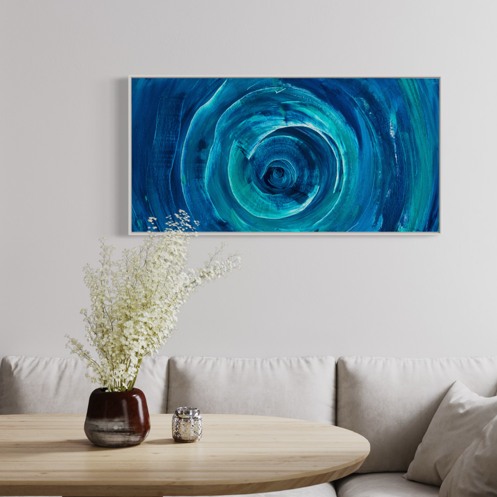 Add a splash of blue to your space with this modern abstract framed canvas print. A perfect addition of colour to any space. Choose from framed or non-framed options for a touch of elegance. Displayed on white wall with white fabric couch.