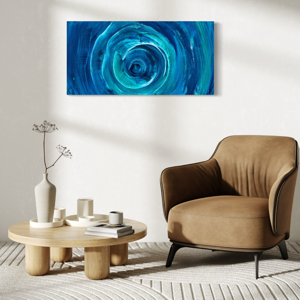 Add a splash of blue to your space with this modern abstract framed canvas print. A perfect addition of colour to any space. Choose from framed or non-framed options for a touch of elegance. Displayed on a white wall with brown fabric chair